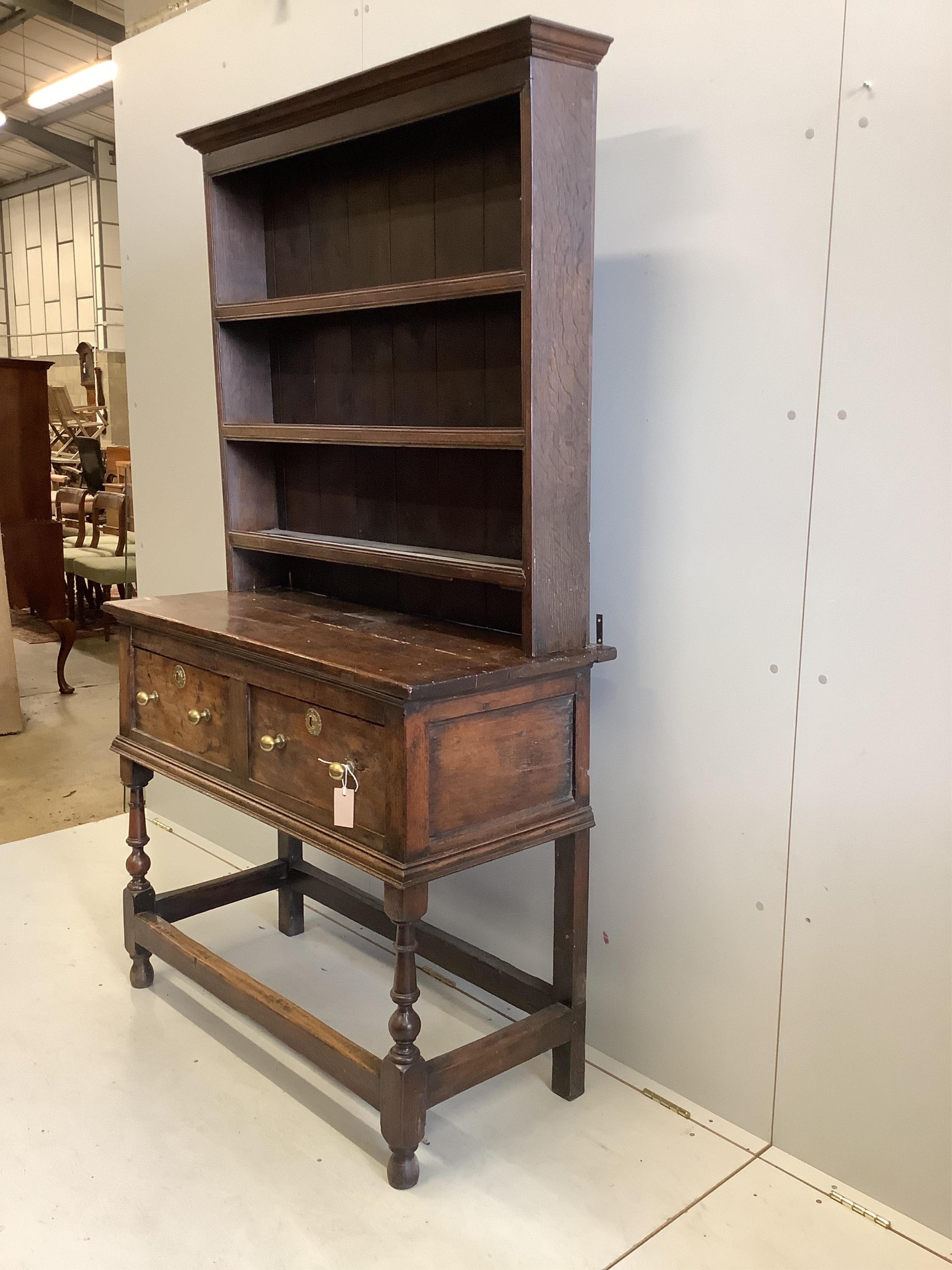 A small mid 18th century oak dresser, width 109cm, depth 49cm, height 191cm. Condition - poor to fair